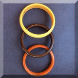 J143. 3 Bakelite bangles in yellow, orange and brown. 